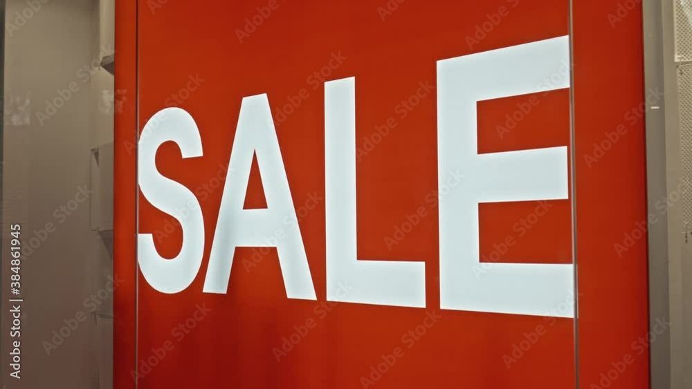 text on the red board window of the store with the inscription sale