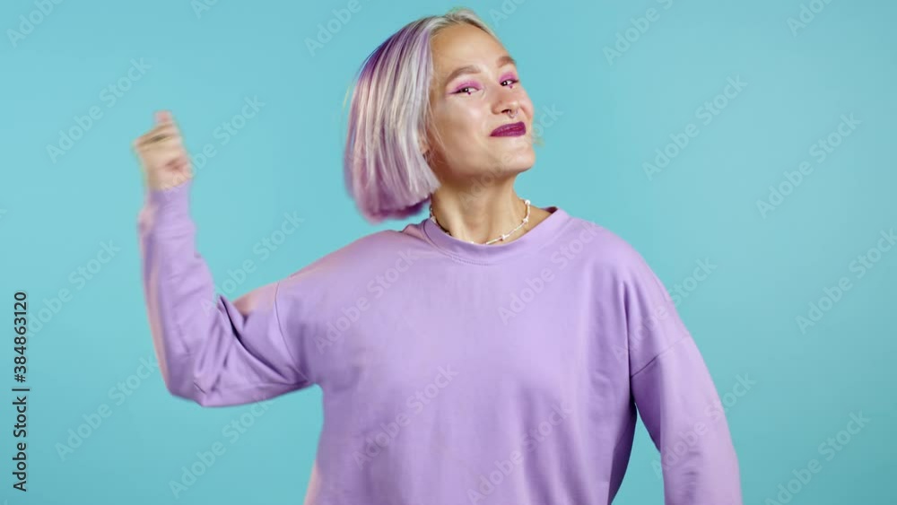 Woman with dyed violet hair very glad, she screaming loud. Woman trying to get attention. Concept of sales, profitable offer. Excited happy lady on blue studio background. Woman with dyed violet hair very glad, she screaming loud. Woman trying to get attention. Concept of sales, profitable offer. Excited happy lady on blue studio background.