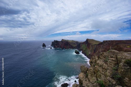 View at the blue ocean and red volcanic cliffs at the Ponta de São Lourenço in Madeira / Portugal 
