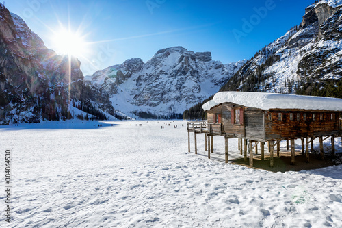 Beautiful, panoramic view to the snow covered lake Lago Di Braies, Pragser Wildsee, in the Italian Dolomites during a cold winter morning