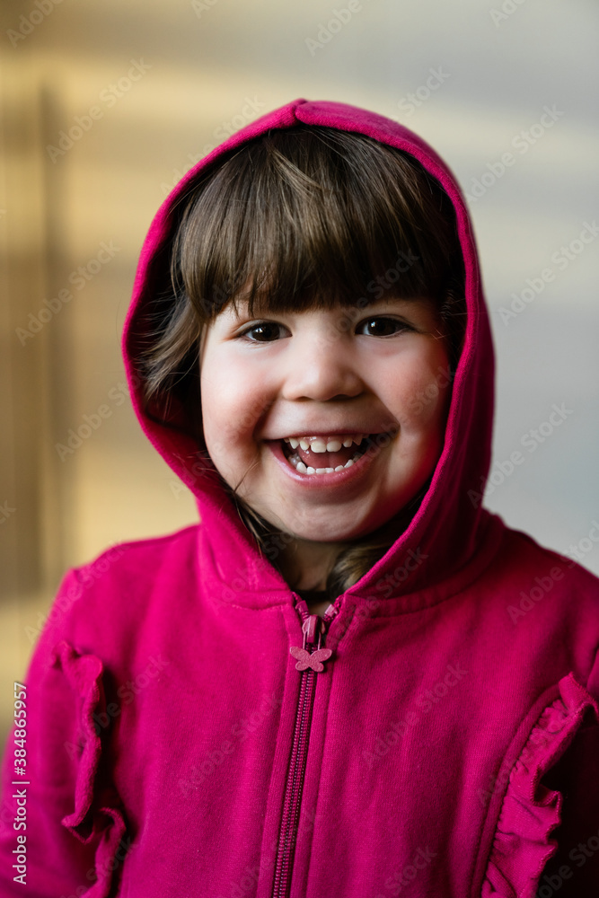 Excited toddler in hoodie at home Excited toddler in hoodie at home
