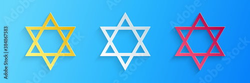 Paper cut Star of David icon isolated on blue background. Jewish religion symbol. Paper art style. Vector.