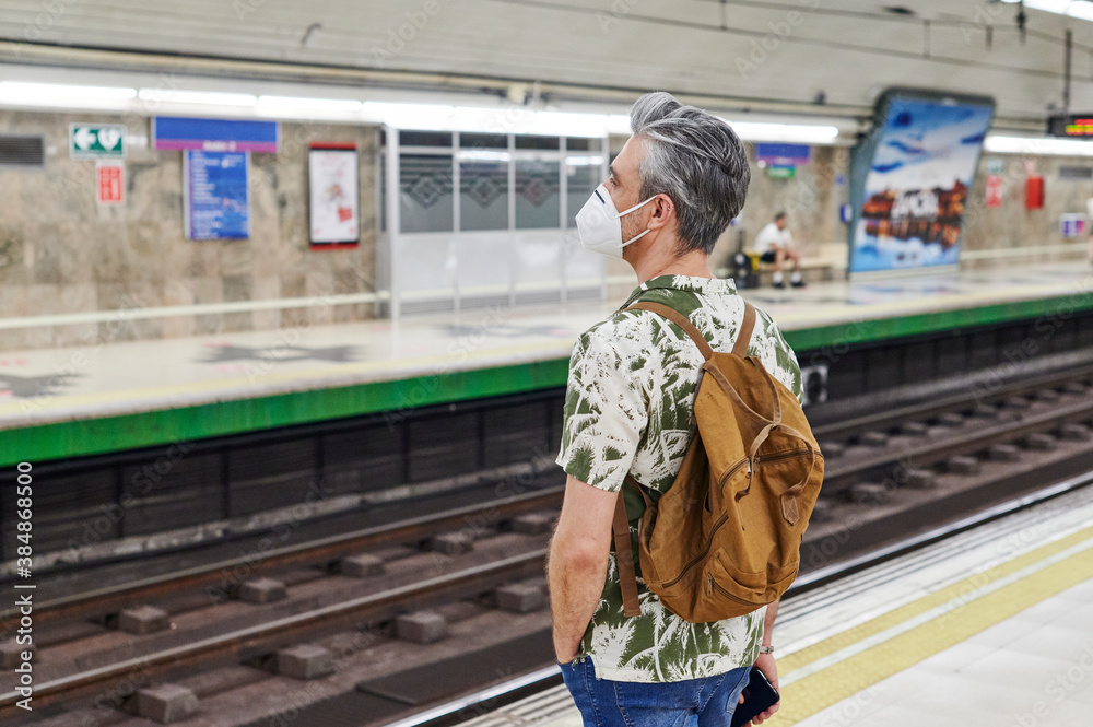 Man in a face mask waiting for a metro train Man in a face mask waiting for a metro train