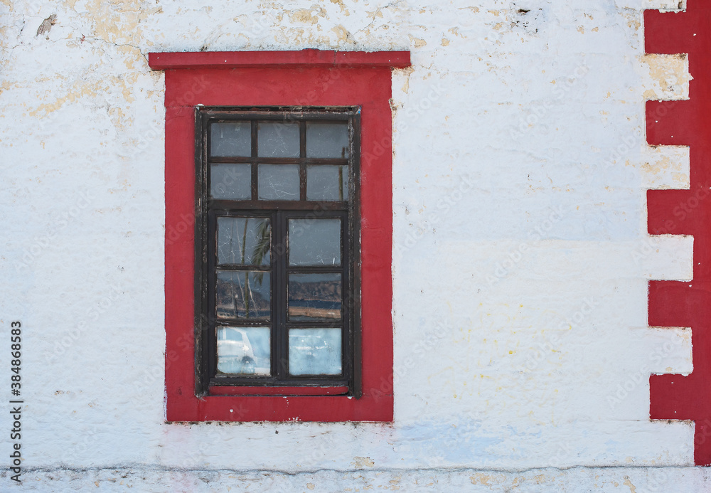 old window on red wall