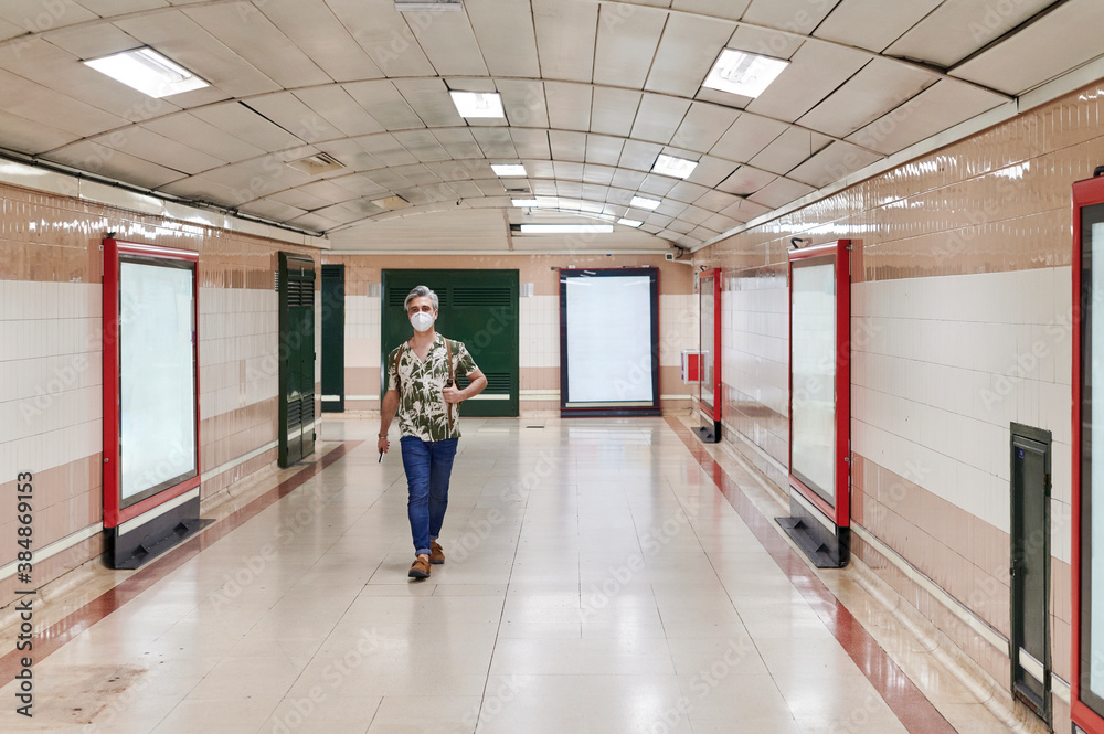 Man walking alone in a subway station Man walking alone in a subway station
