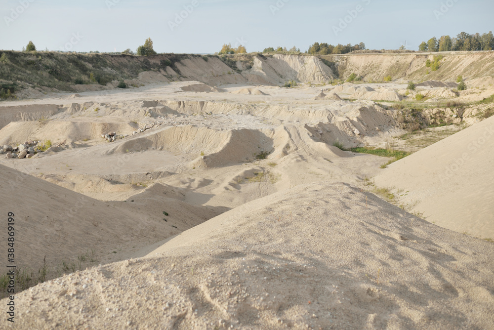 Panoramic view of the quarry on a clear day. Sandy peaks and sand