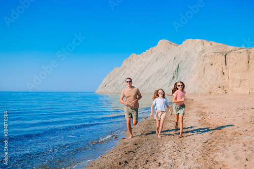Happy beautiful family on a tropical beach vacation © travnikovstudio