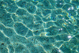 background of cristal clear blue waters with sand on the bottom