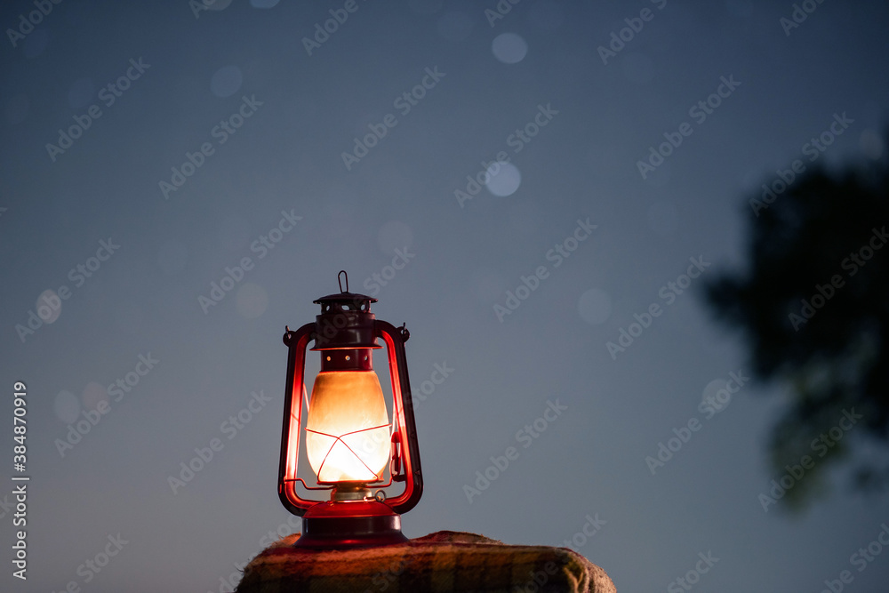 old red petrol lamp in the night. stars background