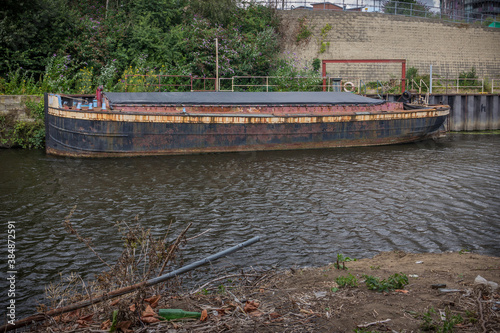 Old decrepit cargo boat on a canal