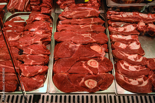 Close-up of raw diced beef in showcase of butcher shop. Bloody Meat Chops.
