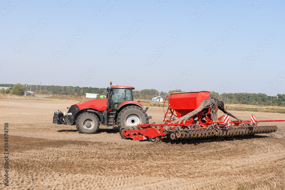Fototapeta premium Tractor on a farmer field