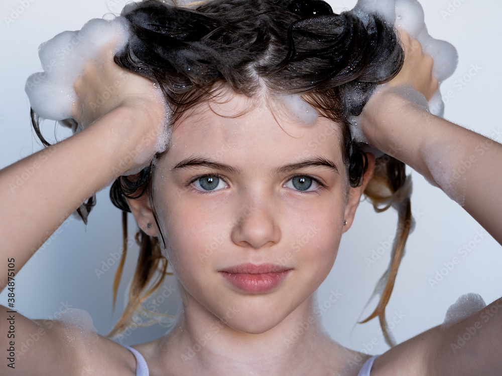 little / young girl washes her hair