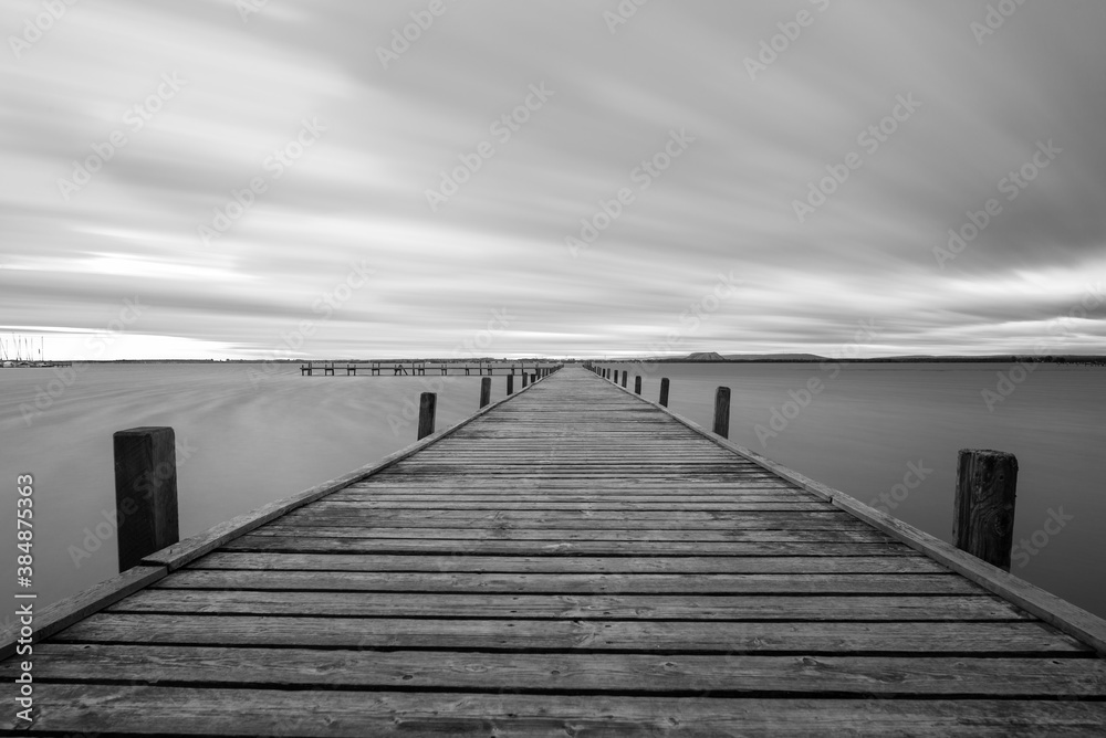 Obraz premium wooden pier with clouds