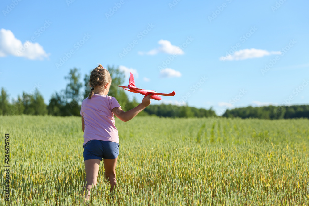 happy child plays with plane in the field happy child plays with plane in the field