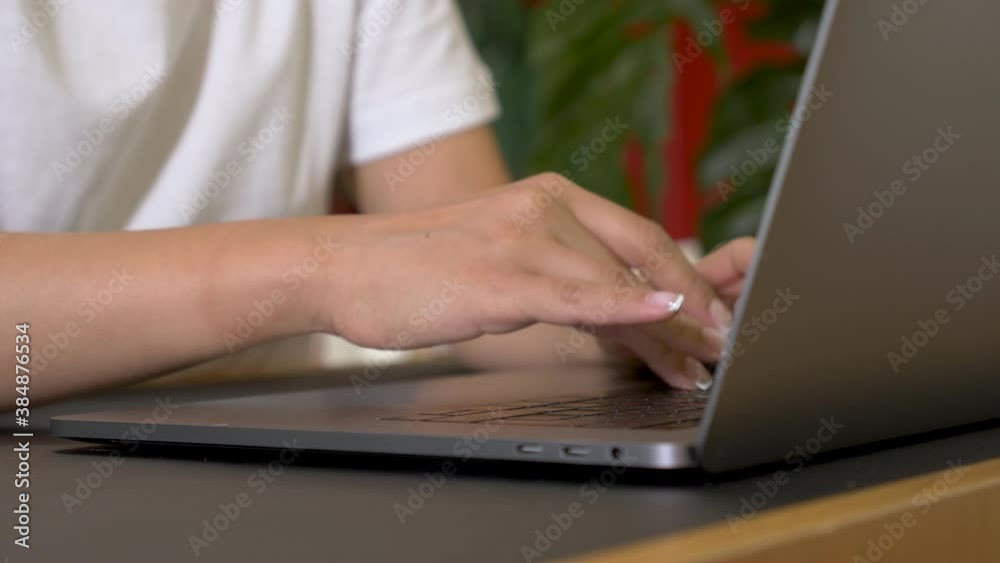 Close-Up of Hands Typing on Computer keyboard. Young Indian Woman Working at Home Office. Bright And Cozy Room At Home. Home Education Learning to know and Finance Close-Up of Hands Typing on Computer keyboard. Young Indian Woman Working at Home Office. Bright And Cozy Room At Home. Home Education Learning to know and Finance