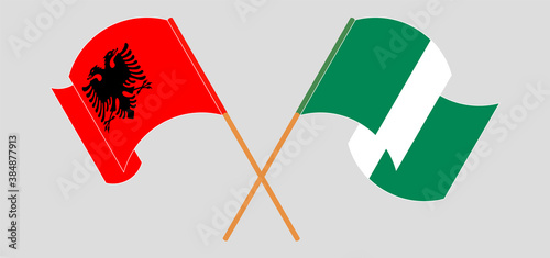 Crossed and waving flags of Nigeria and Albania