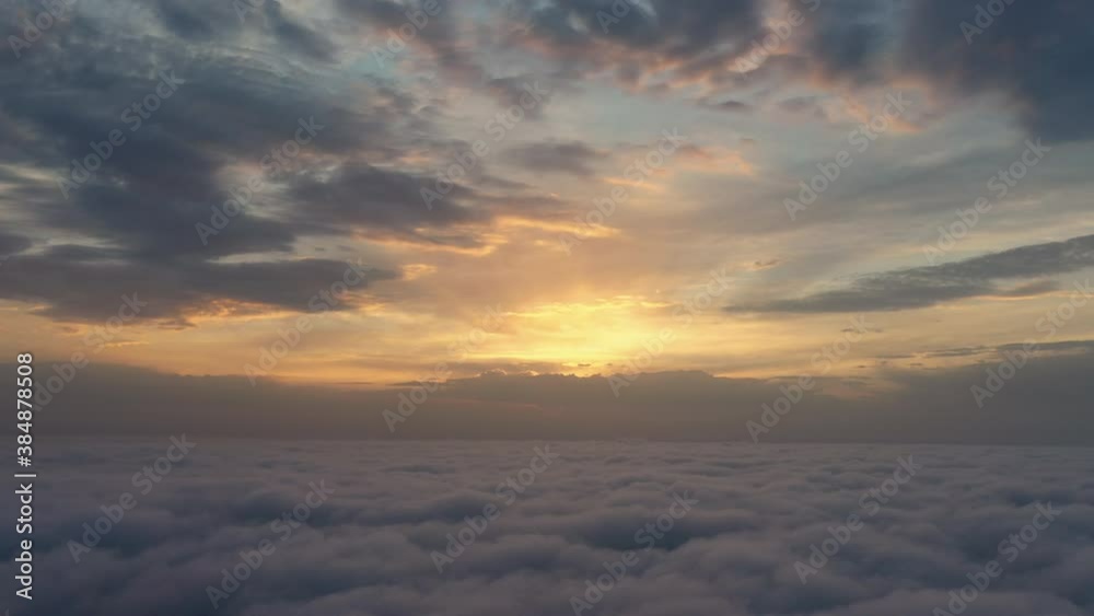 Cloudy sky at sunset with fluffy clouds early morning from aerial view. Drone flight above the clouds. Cloudy sky at sunset with fluffy clouds early morning from aerial view. Drone flight above the clouds.