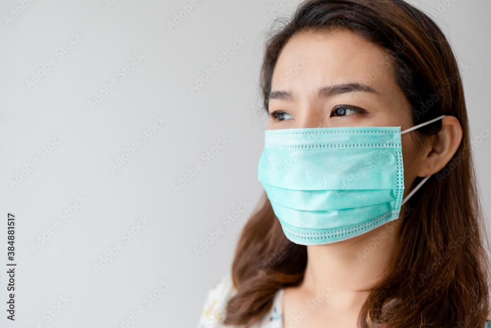 Asian women wear beautiful floral shirts and face masks to prevent the spread of COVID 2019. Health care concept Asian women wear beautiful floral shirts and face masks to prevent the spread of COVID 2019. Health care concept