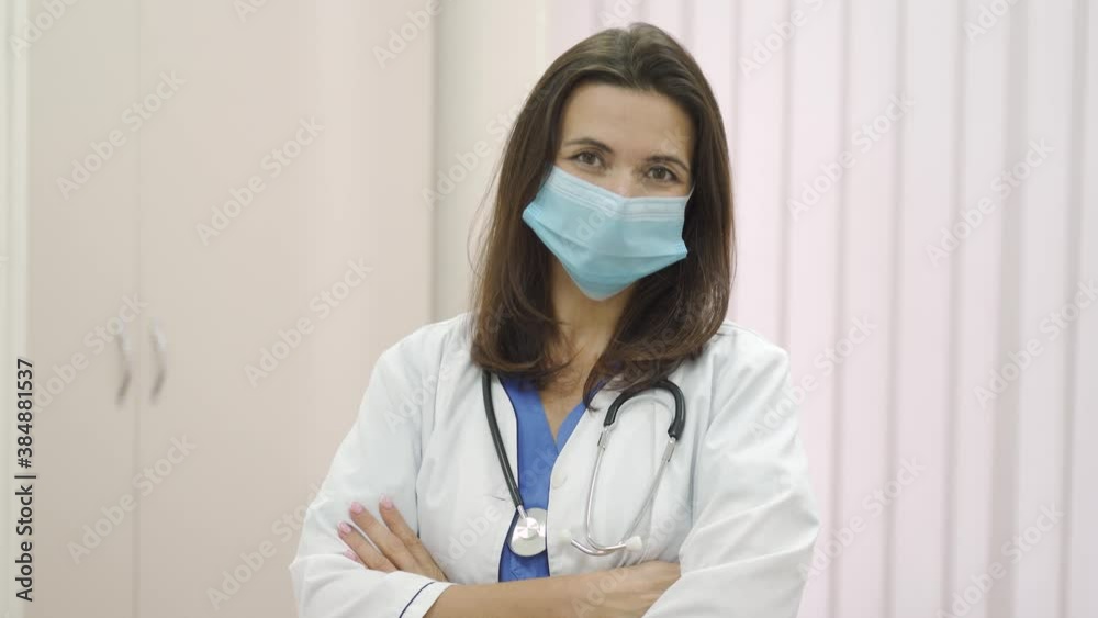 Portrait of young woman female doctor wearing medical face mask indoors. Portrait of young woman female doctor wearing medical face mask indoors.