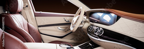 Modern luxury car Interior - steering wheel, shift lever and dashboard. Car interior luxury. Beige comfortable seats, steering wheel, dashboard, speedometer, display. Red and white perforated leather.