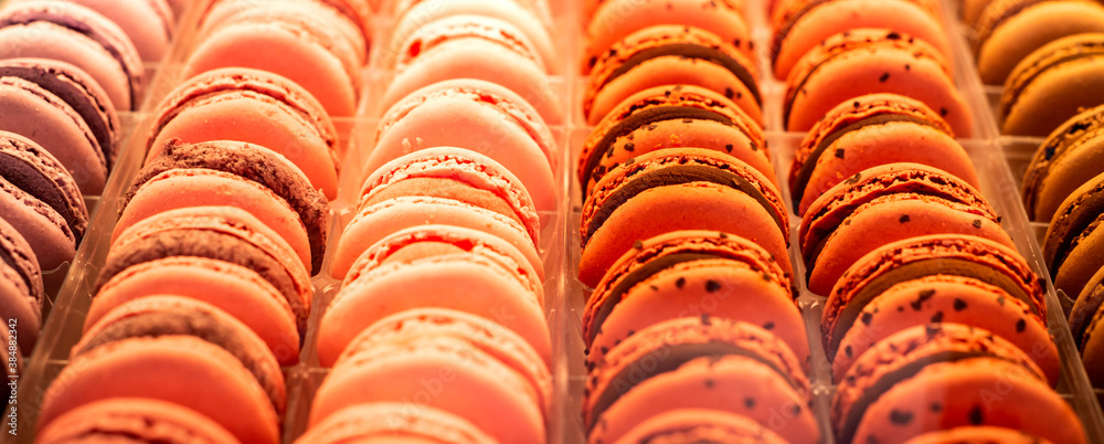 Colorful french macarons background, close up. Different colorful macaroons background. Tasty sweet color macaron, Bakery concept. Selective focus