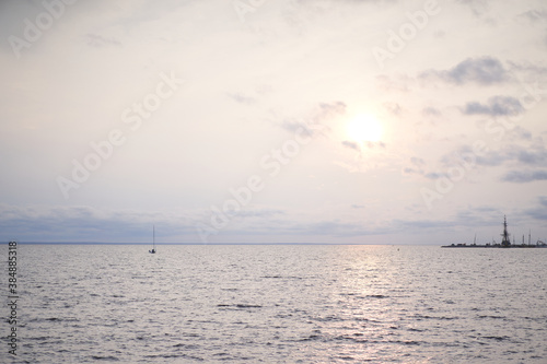 sunset on the beach with orange sun and glare on the water