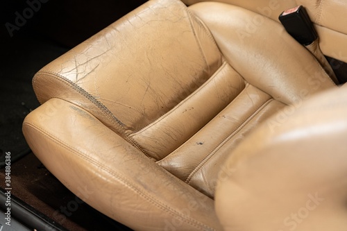 Obraz na płótnie Old cracked damaged leather on car leather upholstery. w salonie