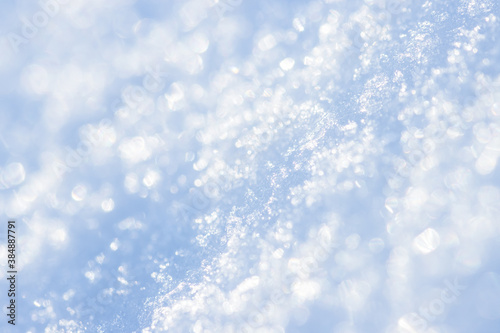 Snow close-up. Winter background with snow texture and beautiful bokeh. Shallow depth of field and blur. Perfect for Christmas and New Year design. View with copy space.