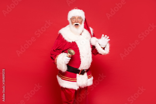 Real Santa Claus posing on red studio