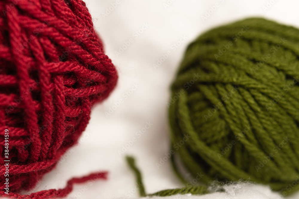 Fototapeta premium Red and green wool balls on Cotton Clouds