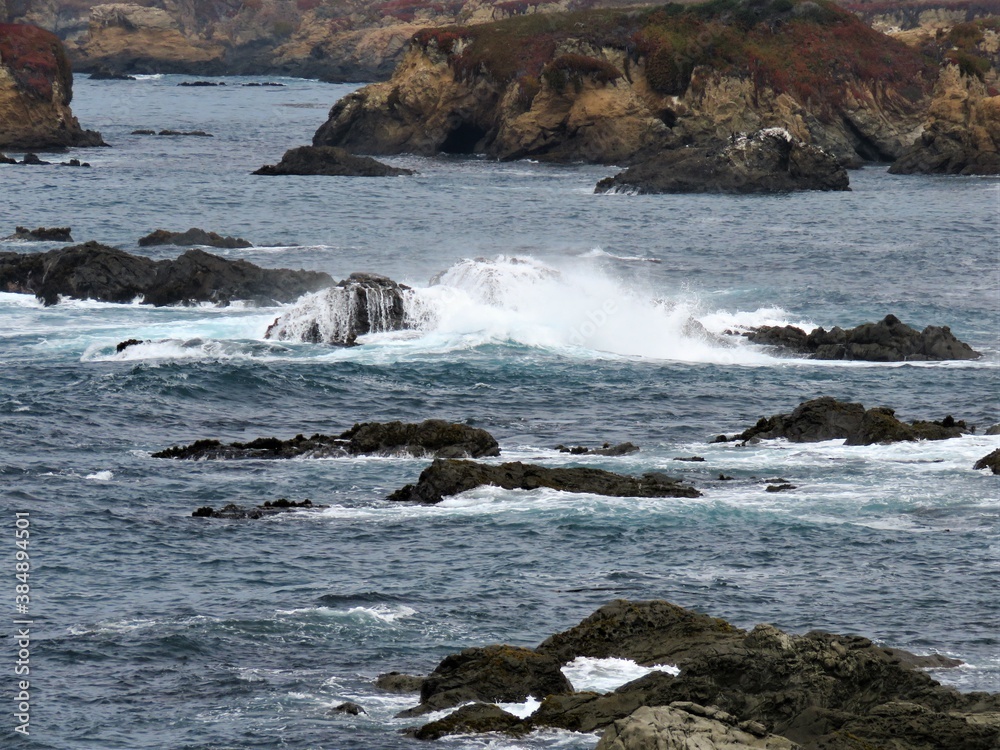 View of the Pacific Ocean and splashing water on the rocks View of the Pacific Ocean and splashing water on the rocks