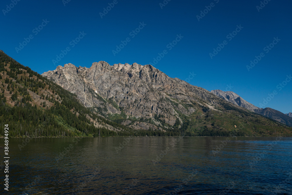 Jenny Lake Trail in Grand Teton National Park, Wyoming. USA. Back to Nature concept. Jenny Lake Trail in Grand Teton National Park, Wyoming. USA. Back to Nature concept.