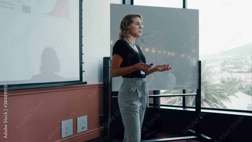 Business woman giving presentation with attendees clapping hands. Business people applauding after successful presentation.
