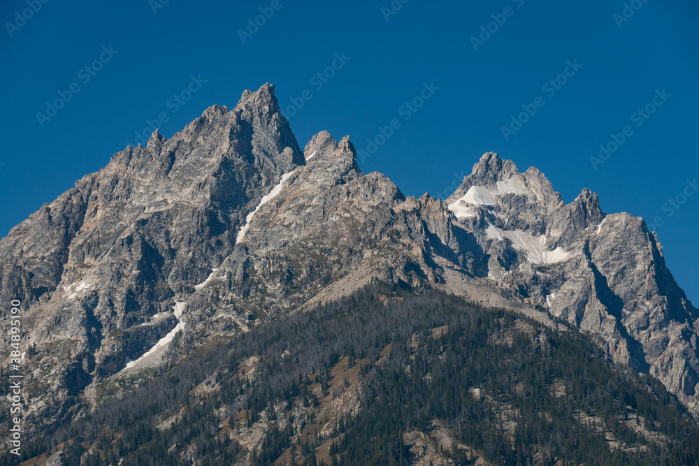 The Teton Range of the Rocky Mountains in North America. Jenny Lake Trail in Grand Teton National Park, Wyoming. USA. Back to Nature concept. The Teton Range of the Rocky Mountains in North America. Jenny Lake Trail in Grand Teton National Park, Wyoming. USA. Back to Nature concept.