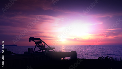 Empty beach and deckchair on a sunset background.