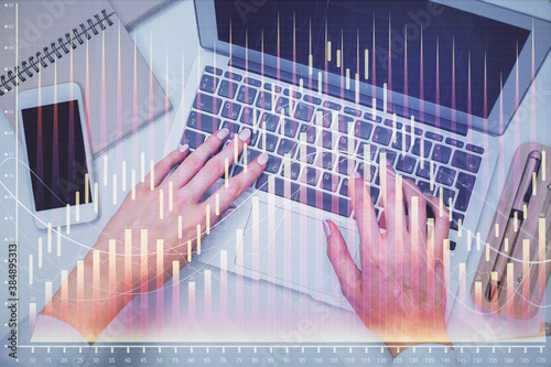 Double exposure of woman hands working on computer and forex graph hologram drawing. Top View. Financial analysis concept. © peshkova