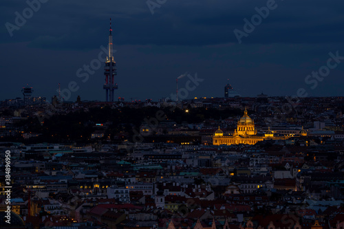 view of the roofs of buildings in the city of prague and the enlightened national museum from 1818 in the czech republic at night