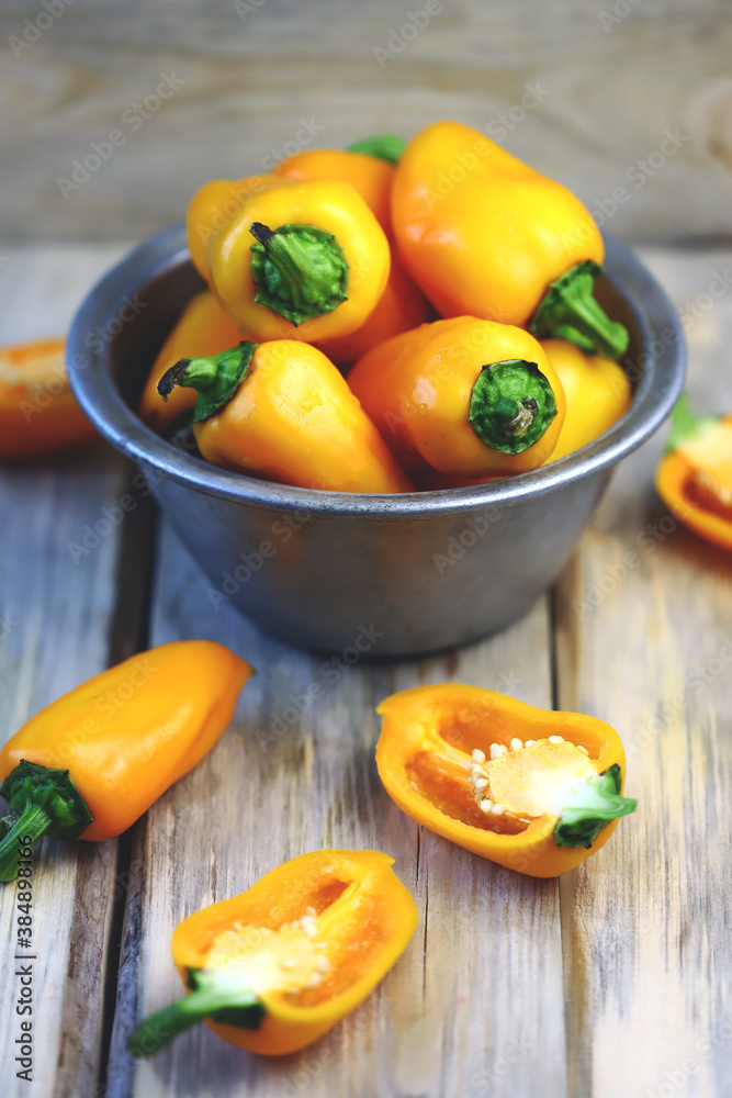 Selective focus. Yellow sweet peppers in a bowl. Autumn vegetables.