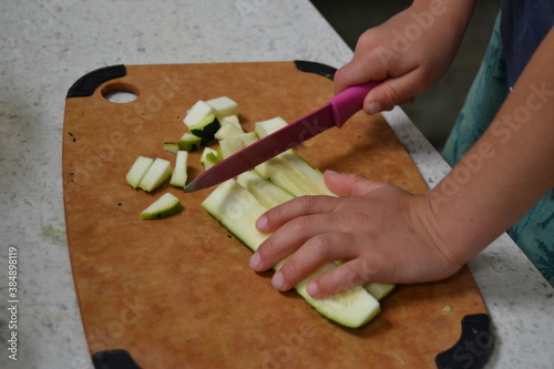The child cutting vegetables