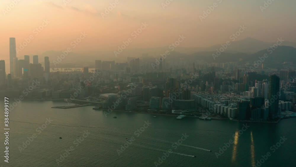 AERIAL. Hong Kong skyline. Hong kong aerial cityscape with sunset sun AERIAL. Hong Kong skyline. Hong kong aerial cityscape with sunset sun