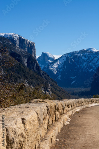 Rock Wall along Edge of Road in the Mountains at Yosemite Park with Blue Sky Background.