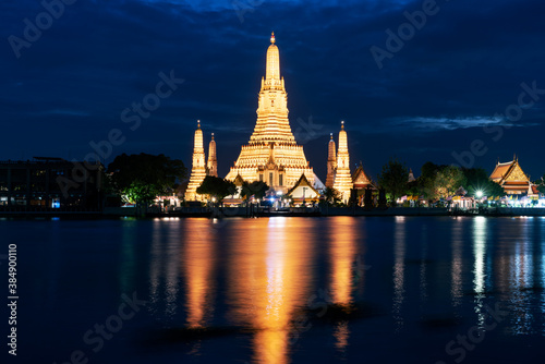 Beautiful Wat Arun Ratchawararam temple with reflexion in the river at twilight in Bangkok Thailand.