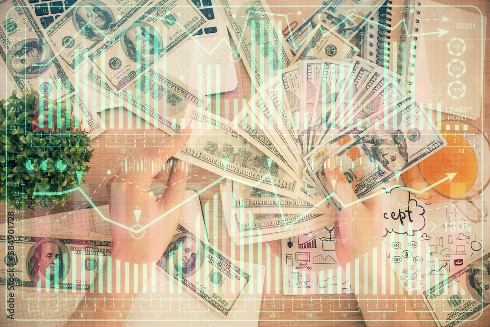 Multi exposure of financial graph drawing hologram and USA dollars bills and man hands. Analysis concept. Multi exposure of financial graph drawing hologram and USA dollars bills and man hands. Analysis concept.