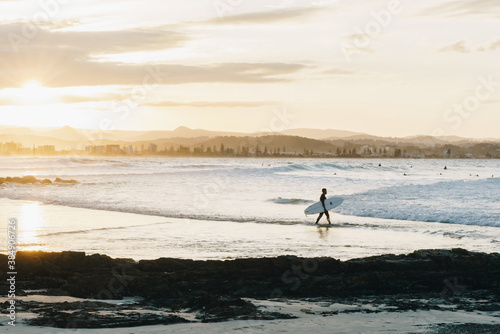 Surfer walking in at Greenmount, Queensland Gold coast