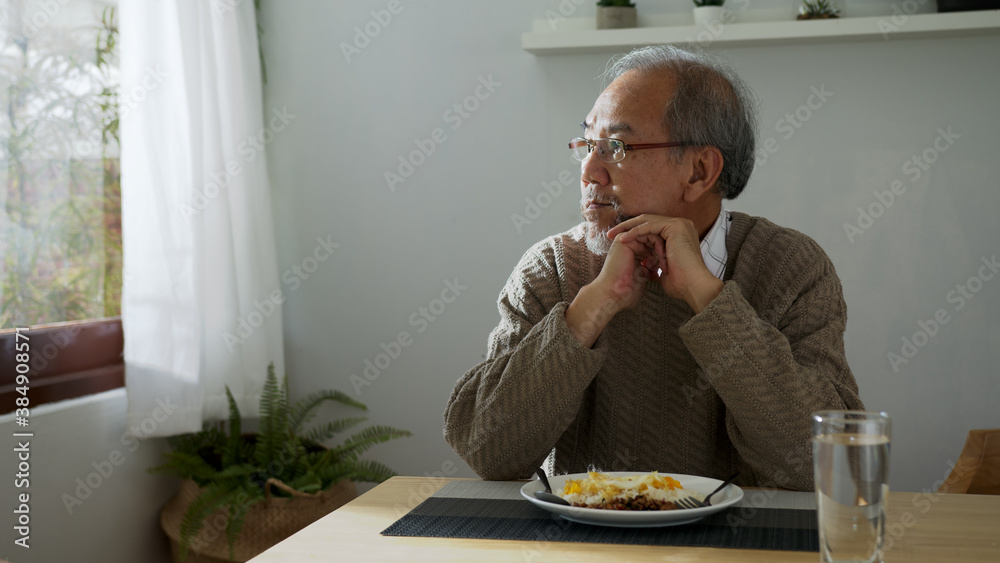 Sad old retired gray haired grandpa asian man sitting alone at table desk at window boring stay home self isolation quarantine feeling depress in problem mental health. Sad old retired gray haired grandpa asian man sitting alone at table desk at window boring stay home self isolation quarantine feeling depress in problem mental health.