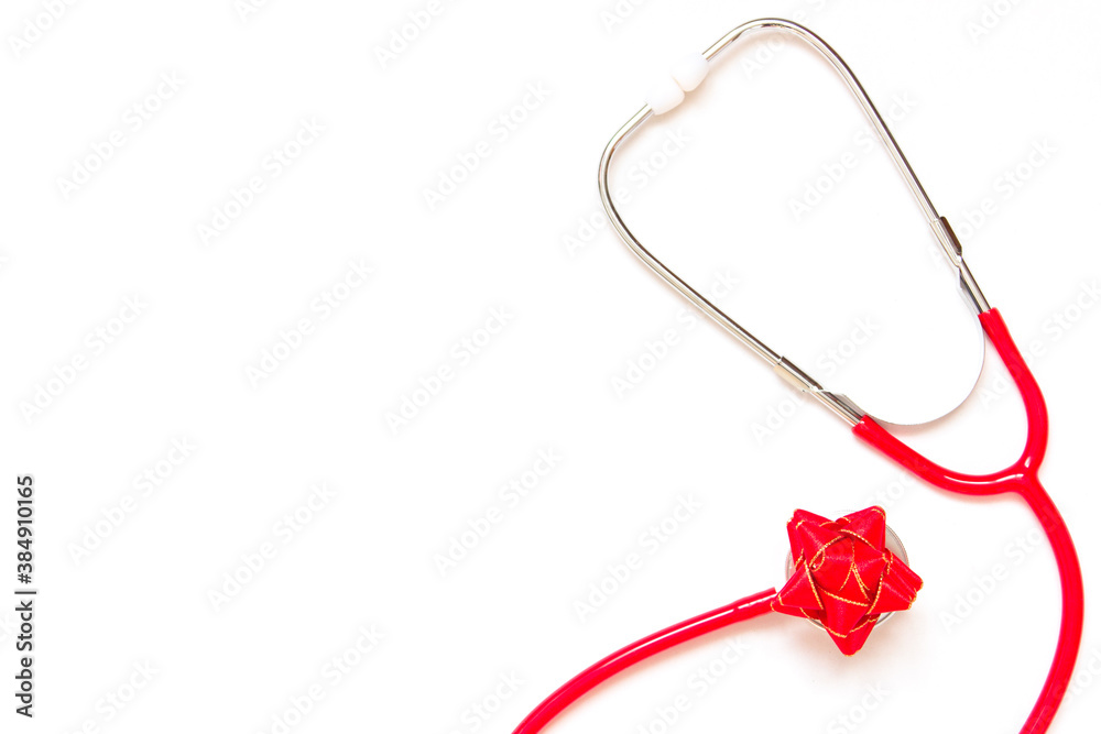 Medical red stethoscope with holiday red bow on white background. Copy space. Medical red stethoscope with holiday red bow on white background. Copy space.
