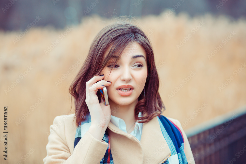 Skeptical woman talking on phone deciding what to answer Skeptical woman talking on phone deciding what to answer