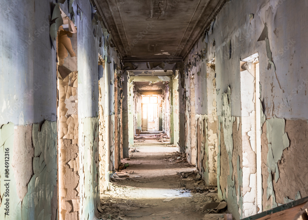 Corridor in an abandoned building on the ruins. Light at the end of the corridor