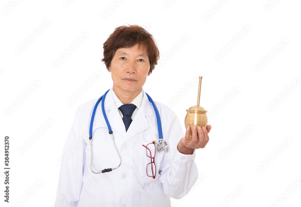 Female doctor in white lab coat holding medicine mortar in hand and looking at camera in front of white background Female doctor in white lab coat holding medicine mortar in hand and looking at camera in front of white background
